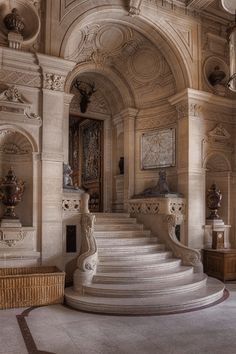 an ornately decorated room with stairs and sculptures