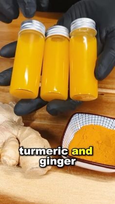 two hands holding jars of turmeric and ginger