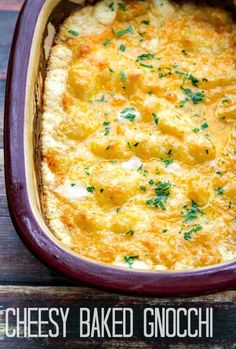 cheesy baked gnocchi in a casserole dish with parsley on top