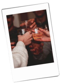 several people are toasting with wine glasses in their hands while holding each other's hands