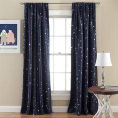 the curtains are hanging in front of the window with stars and moon prints on them