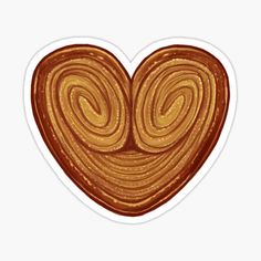 a heart shaped cookie sticker with swirls on the top and bottom, in gold