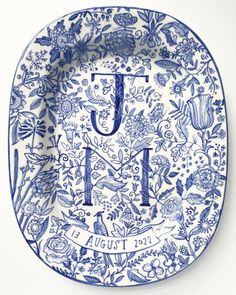 a blue and white plate with the letter j on it