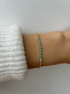 This dainty bracelet is just perfect for the summer and is also the birthstone of anyone born in the month of December. D E T A I L S  *Made with micro-faceted genuine turquoise rondelles that originate from Mexico.  *These are a beautiful  greeny blue colour with matrix inclusions and measure around 2mm. *They are separated by seamless gold filled/sterling silver beads. *Choose between and 18k gold filled chain, rose gold filled  or 925 sterling silver chain. *Gold filled is a wonderful alternative to solid gold and unlike gold plating does not rub off. *It closes with a hallmarked  spring ring clasp. *Bracelet comes with a matching crystal information card and is ready for gifting. C A R E  * T I P To keep your bracelet in great condition please avoid contact with water, perfume and chem Turquoise Round Bead Jewelry For Everyday, Everyday Turquoise Jewelry With Round Beads, Adjustable Turquoise Bracelet With Birthstone, Turquoise Sterling Silver Jewelry With Tiny Beads, Everyday Hand-strung Turquoise Jewelry, Everyday Turquoise Nickel-free Bracelets, Everyday Turquoise Hand-strung Jewelry, Dainty Sterling Silver Beaded Bracelets With Tiny Beads, Dainty Nickel-free Beaded Bracelets