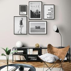 a living room with pictures on the wall and a chair next to a coffee table