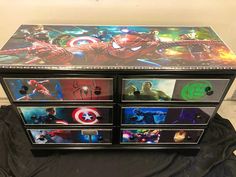 the drawers are decorated with pictures of avengers and spider - man's faces on them