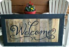 a welcome sign sitting on top of a wooden chair next to a potted plant