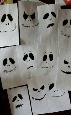 several paper bags with faces drawn on them