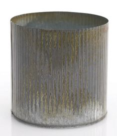 a round metal container sitting on top of a white table