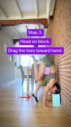 a woman is bending over on the floor with her legs up and head on block