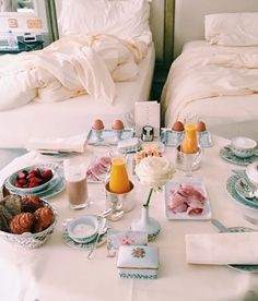 two twin beds with breakfast foods on them