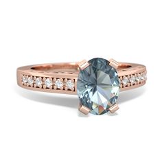 a rose gold engagement ring with an aqua blue topazte and white diamond accents