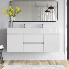 a white bathroom with two sinks and a large mirror