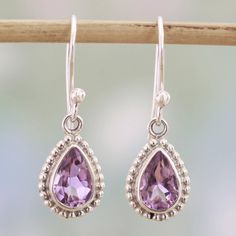 Three carats of teardrop amethyst stones sparkle with lilac colors in these dangle earrings from India. Neeru Goel expresses her childhood passion for jewelry and gemstones, giving these earrings a handcrafted design from sterling silver with petite dot motifs surrounding the stones.