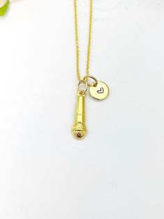 "This is a gold -tone Microphone charm with hand stamped initial charm on brass/stainless steel 18 inches chain. ♥ You will receive 1 necklace. HOW TO ORDER 1) Select the quantity 2) Select the initial  3) Add to cart DESCRIPTION ♥ Necklace, Gold Plated over Stainless steel or Brass Cable Chain with Lobster Claw Clasp, Size: about 17.7 inches (45cm) long, 1-2mm wide, Nickel Safe, ♥ Initial Charms, Gold Plated over Stainless steel, Size: about 8-10mm in diameter, 1mm thick, Nickel Safe, ♥ Microphone Charm, 304 Stainless Steel Pendants, Textured, Microphone, Golden, Size: about 0.24 inch(6mm) wide, 0.79 inch(20mm) long, 0.10 inch(2.5mm) thick PLEASE READ: *Materials and style may be different from the list depend on stock and style of the jewelry* Due to the shipping supply and the fee being Adjustable Gold Hand Stamped Charm Necklaces, Adjustable Hand Stamped Gold Charm Necklaces, Gold Stamped Initial Pendant Charm Necklace, Personalized Stamped Gold Charm Necklace, Personalized Gold Charm Necklaces In Brass, Personalized Gold Brass Charm Necklaces, Gold Stamped Charm Necklaces As Gift, Gold Microphone, Jewelry Card