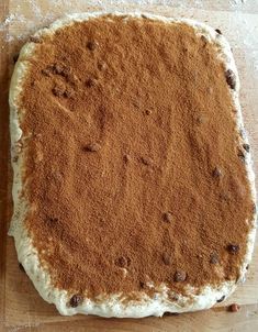 an uncooked cake sitting on top of a wooden cutting board