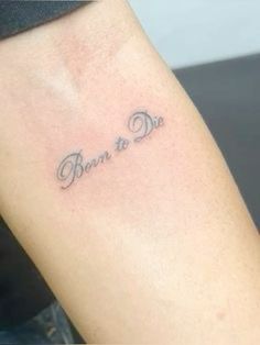 a woman's arm with the words born to die tattooed on her left arm