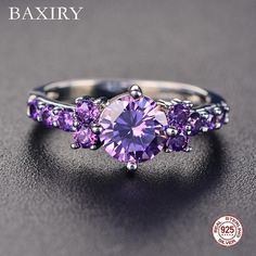 three stone ring with purple stones on the side