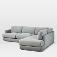 a gray couch and ottoman sitting next to each other