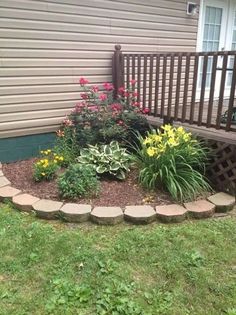 a flower bed in front of a house