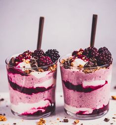 two desserts with berries and whipped cream on top