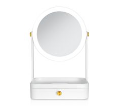 a white vanity mirror sitting on top of a table