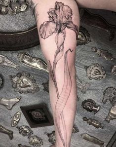 a woman's leg with a tattoo on it and a flower in the middle