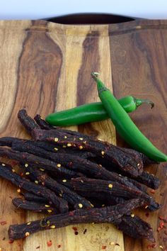 some beans and green peppers on a wooden table