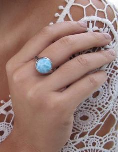 Larimar  round vintage ring handmade with high quality larimar and craftmanship.  These rings are handcrafted by talented Dominican Artisans. Each Gemstone is only in appearance; giving this timeless piece it's own uniqueness and beauty. Product Details: Larimar Stone Dimension: 10 mm Highly polished .925 Sterling Silver Top quality larimar stone. Unique Larimar Turquoise Ring As Gift, Handmade Turquoise Larimar Ring For Anniversary, Blue Larimar Round Rings, Handmade Turquoise Larimar Rings, Turquoise Larimar Round Ring, Turquoise Larimar Ring, Blue Larimar Moonstone Ring, Unique Turquoise Moonstone Ring, Round Larimar Rings As A Gift