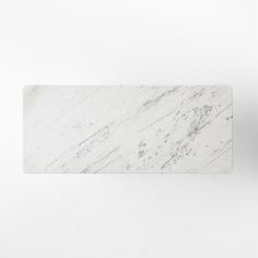 a white marble business card sitting on top of a table