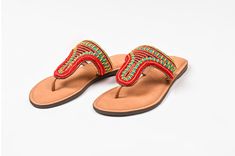 Say hello to gorgeous feet with our tribal fusion slider sandals. With hand-beaded detailing in an Indian tribal pattern, these sandals shine with pops of reds, greens, and blues. Crafted with 100% soft leather for your comfort. Indian tribal fusion boho sandals Hand-beaded detailing in reds, greens, and blues Crafted from 100% leather Handcrafted by artisans Hello, gorgeous feet! Our tribal fusion slider boho sandals promise to adorn your feet beautifully. The Indian tribal-inspired beaded patt Traditional Green Open Toe Sandals, Bohemian Green Festival Sandals, Red Beaded Sandals For Summer, Bohemian Green Sandals For Festival, Green Bohemian Sandals For Festival, Traditional Red Sandals For Summer, Traditional Red Sandals For Vacation, Traditional Red Sandals For Festival, Blue Crafts