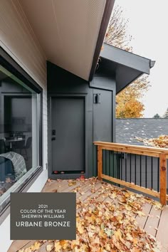 the front porch is covered in leaves and has a sign that reads, urban bronze