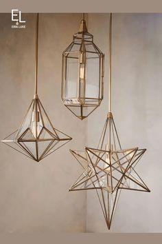 three hanging lights in different shapes and sizes, one with a star on the top