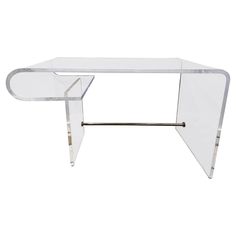 a clear glass table with metal legs