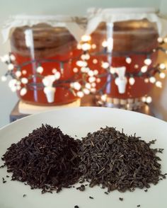 two bags of tea sitting on top of a white plate