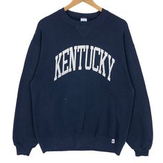 Vintage 90s University Of Kentucky Wildcats crewneck sweatshirt by Russell Athletic in navy blue colour. Pullover sweater with printed spell out logo on the front. Still in good condition EXCEPT few drops of paint stains on the front and slightly defect (tear) on the left wrist. SEE THE PICTURES FOR MORE DETAILS. CONDITION : 7/10 MEASUREMENT Pit : 22 inch Length : 28 inch Shoulder : 22 inch Arm Length : 24 inch Size On Tag : L Recommended Size : M PAYMENT We accept PayPal only. The item will be Navy Sweater For College In Fall, Collegiate Crew Neck Sweatshirt With Ribbed Cuffs, Navy College Sweater, Crew Neck Sweater For Campus In Winter, Winter Crew Neck Sweater For Campus, Collegiate Crew Neck Sweater With Graphic Print, Collegiate Crew Neck Sweatshirt For Campus, Navy Cotton Collegiate Sweatshirt, Crew Neck Casual Sweater For College