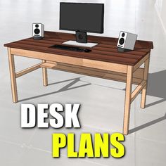 a desk with a monitor, keyboard and speakers sitting on it's top that says desk plans