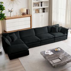 a living room with a large black couch