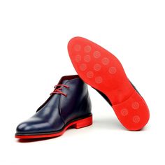 Easily identifiable by it's unique height, chukka boots have recently become a staple for men looking to dress well while still being casual. A Chukka boot adds comfort and versatility to any wardrobe. The Details: Materials: navy box calf Lining: red calf leather Sole: red heeled rubber sole Last: Zurigo - Rounded Toe for Traditional English Look The Fine Print: Shoe production timeline/shipping Can vary from 15-30 days from the date of order. All shoes are handmade, small tinny changes or impe Dress Boots For Men, Leather Dress Boots, Mens Dress Boots, Stylish Suit, Red Bottom, Dress Well, Chukka Boot, Red Heels, Red Bottoms