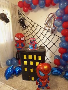 a spiderman birthday party with balloons and decorations