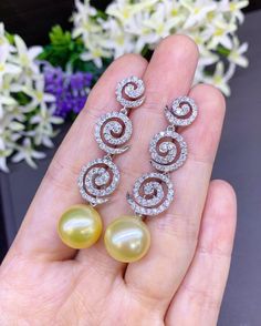 We are presenting you A UNIQUE PAIR OF HUGE 13.5MM SOUTH SEA PEARLS with LUSTROUS GOLDEN color. SET IN HANDCRAFTED, 18K SOLID GOLD Chandelier EARRINGS. ACCENTED WITH 132 F/VS, SPARKLING ROUND BRILLIANT DIAMONDS! Set in 18K Solid White Gold earrings! IN CASE OF RETURN FOR US BUYERS. BUYERS MAY SEND THE ITEMS BACK TO OUR US-BASED OFFICE IN SALT LAKE CITY, UTAH ONLY ONE ITEM AVAILABLE!! NO DUPLICATES!! WHAT YOU SEE IN THE PICTURES IS WHAT YOU WILL GET SOLIDLY HANDCRAFTED EARRINGS! SUGGESTED RETAIL White Gold Round Pearl Earrings For Party, Party Pearl Drop Earrings, Elegant Yellow Bridal Earrings For Wedding, Gold Chandelier Earrings, Golden South Sea Pearls, Cocktail Wedding, Gold Chandelier, Wedding Cocktails, White Gold Earrings