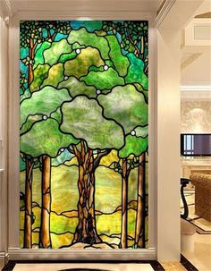 a large stained glass window with trees on it