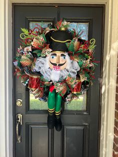 a wreath with a man's face on it is hanging from the front door