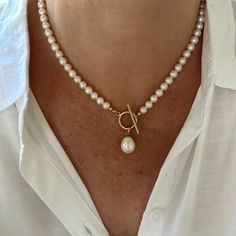 This classic white pearl necklace features a gorgeous 12x15mm smooth teardrop white freshwater pearl that drops elegantly from the gold filled toggle clasp. The necklace is made with 6mm high quality genuine AAA grade natural round freshwater pearls that have high luster and luminescence. These natural pearls have a superior polish, are perfectly calibrated, and are uniform in size.  - Not dyed, treated or color enhanced. 100% natural. - Photos taken outside in natural lighting and in a light bo Elegant White Toggle Necklace With Pearl Charm, Elegant Toggle Necklace With Pearl Charm, Elegant Pearl Toggle Necklace With Pearl Charm, Classic Pearl Necklace With Toggle Clasp, Elegant Pearl Necklace With Toggle Clasp, Classic Pear-shaped Baroque Pearl Necklace, Classic Necklace With Teardrop Pearl Charm, Classic Teardrop Necklace With Pearl Charm, Classic Pearl Drop Necklace With Pearl Charm