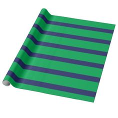 a green and blue striped wrapping paper on a white background with a black strip in the middle