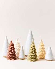 five small white and gold christmas trees lined up