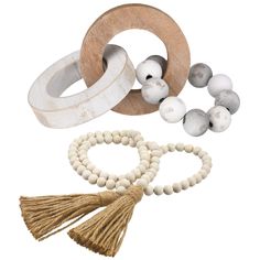 wooden beads and tassels are arranged on a white background, including one beaded bracelet