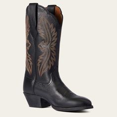 a pair of black cowboy boots with floral designs on the side and brown soles