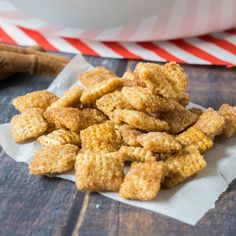 a pile of fried food sitting on top of a piece of paper next to a cinnamon stick