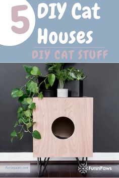 the diy cat house is made out of wood and has plants in it